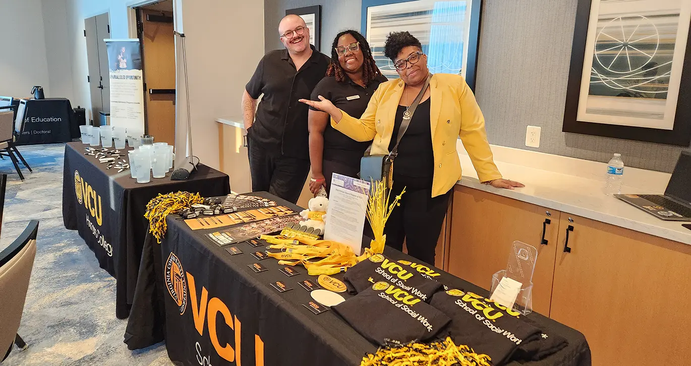 3 members of VCU's recruitment team at an undergraduate admissions event.