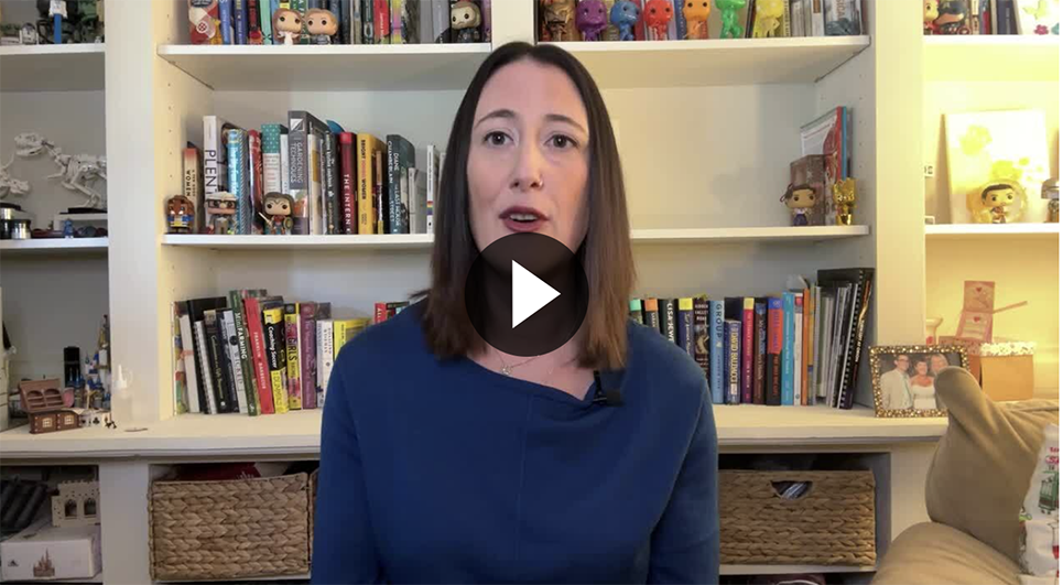 Person in front of a bookcase with video play button overlay